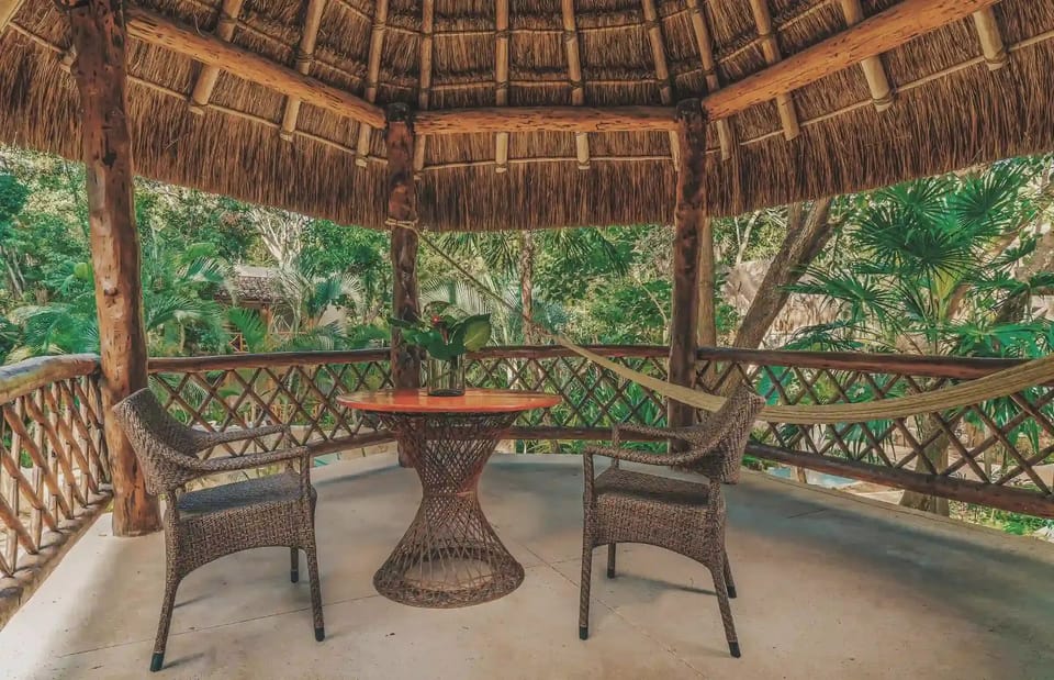 Linger under a palapa terrace, surrounded by tropical greenery.