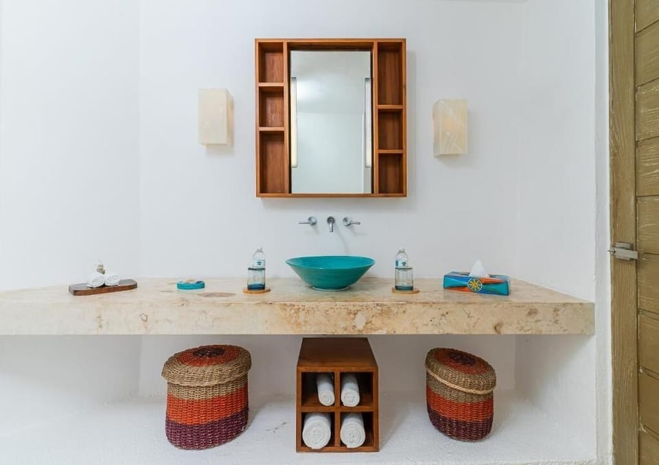 Refresh in a spa-like bath with artisan vessel sink.