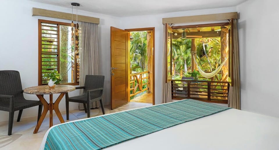 Sip morning coffee as jungle views pour through open doors.