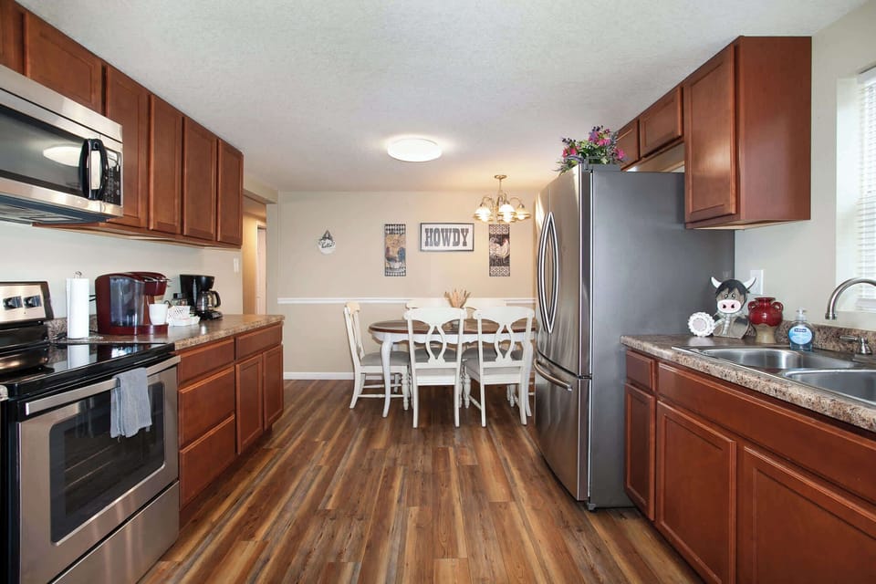 Fully equipped kitchen featuring modern appliances, a coffee station, and a dining area.