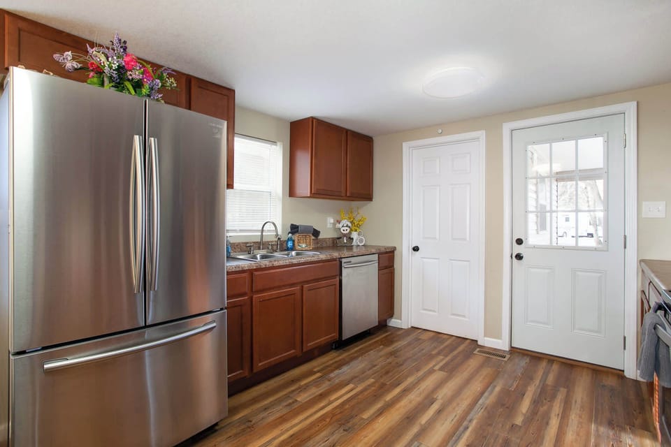 Fully equipped kitchen featuring modern appliances, a coffee station, and a dining area.