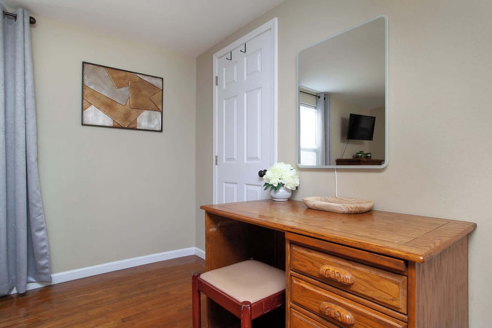 Primary Bed: The room features a large bed with a decorative wrought-iron frame and high-quality linens.