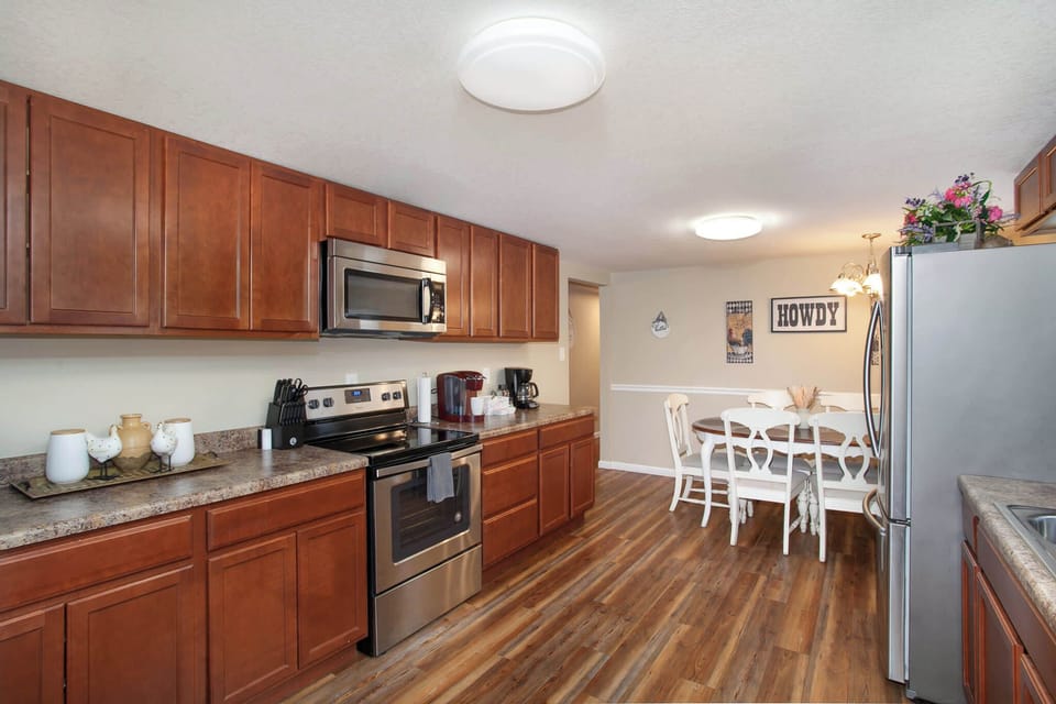 Fully equipped kitchen featuring modern appliances, a coffee station, and a dining area.