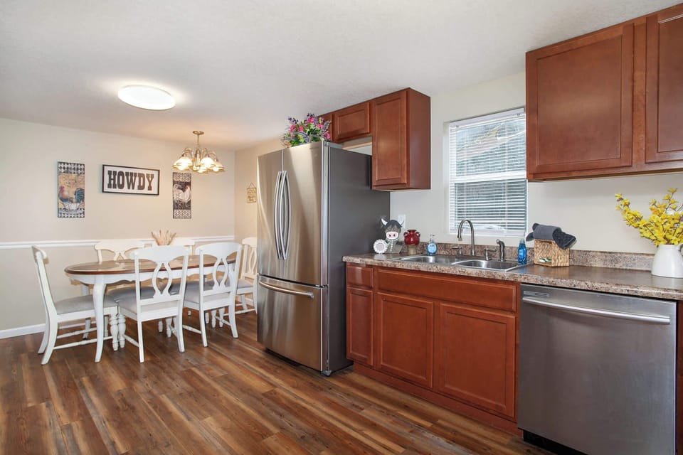 Fully equipped kitchen featuring modern appliances, a coffee station, and a dining area.