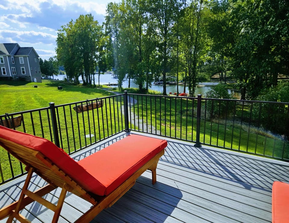 Upper Deck - Relaxing lounger with vibrant cushions provides a perfect vantage point for watching the sunset over the lake.