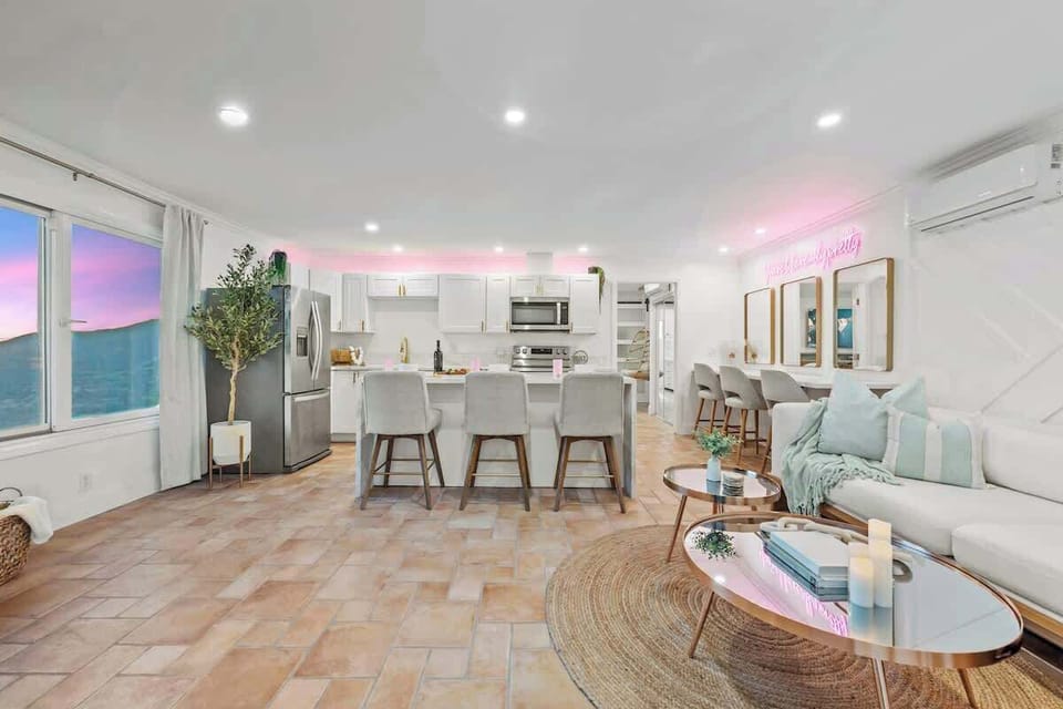 A chic and inviting open-concept space with modern elegance, warm textures, and a touch of glam.