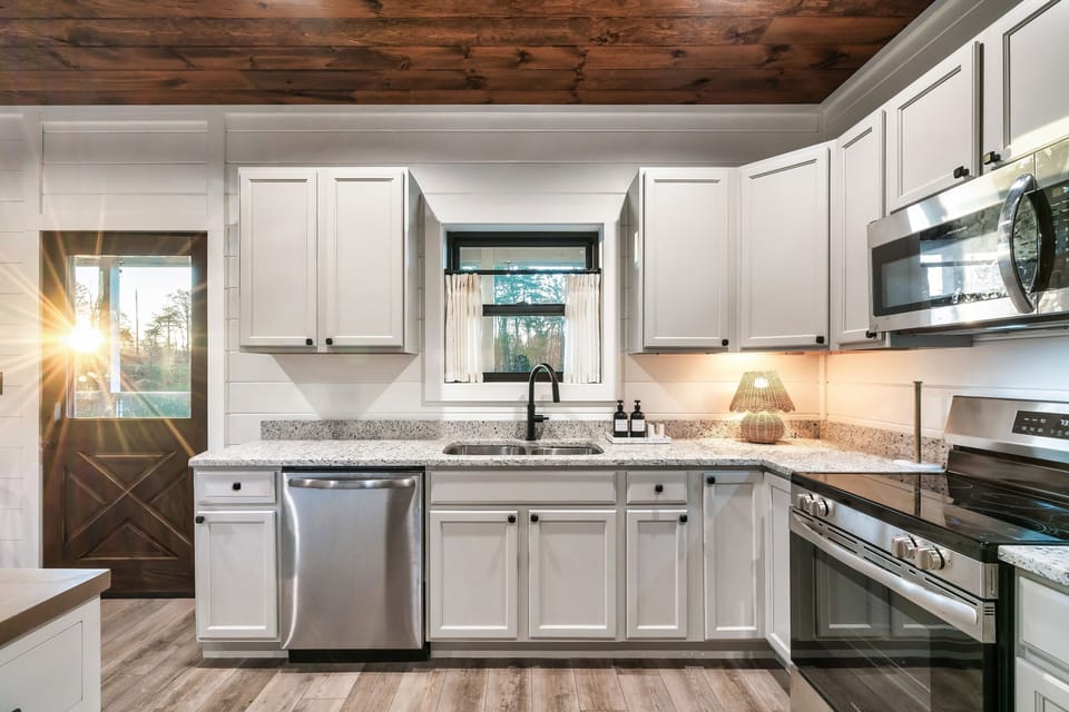 Bright, fully equipped kitchen with a large island, modern appliances, and plenty of space for gathering and meal prep.