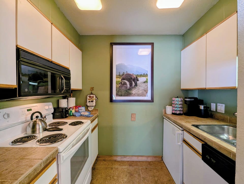 Your fully equipped galley kitchen features everything needed to prepare meals, with a coffee maker ready for morning brews.