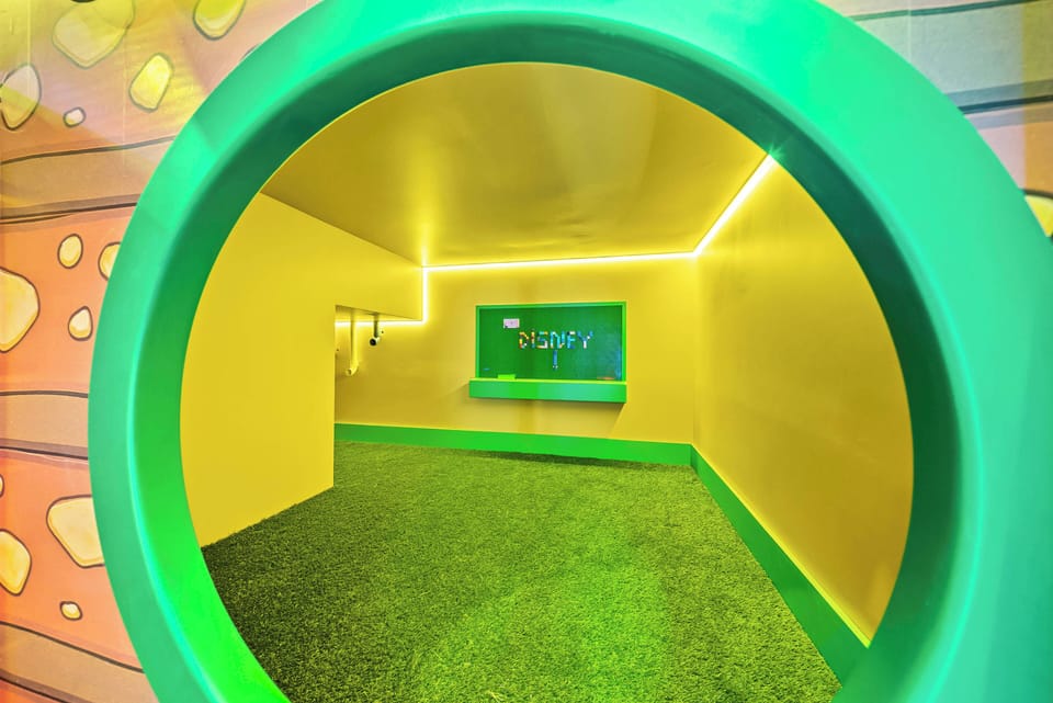 Welcome to a vibrant playroom featuring sunny yellow walls and cheerful green accents that spark creativity. With soft, grass-like flooring for comfort and unique lighting adding whimsy, this space invites fun and relaxation.