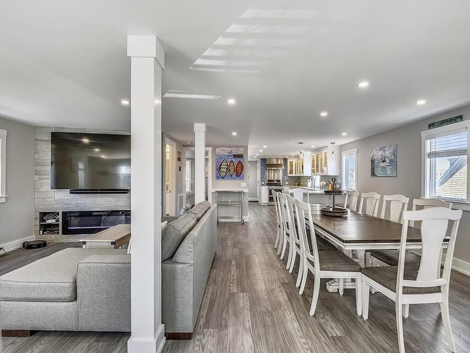 The expansive open-plan living area features a large sectional sofa, perfect for gathering with family and friends.