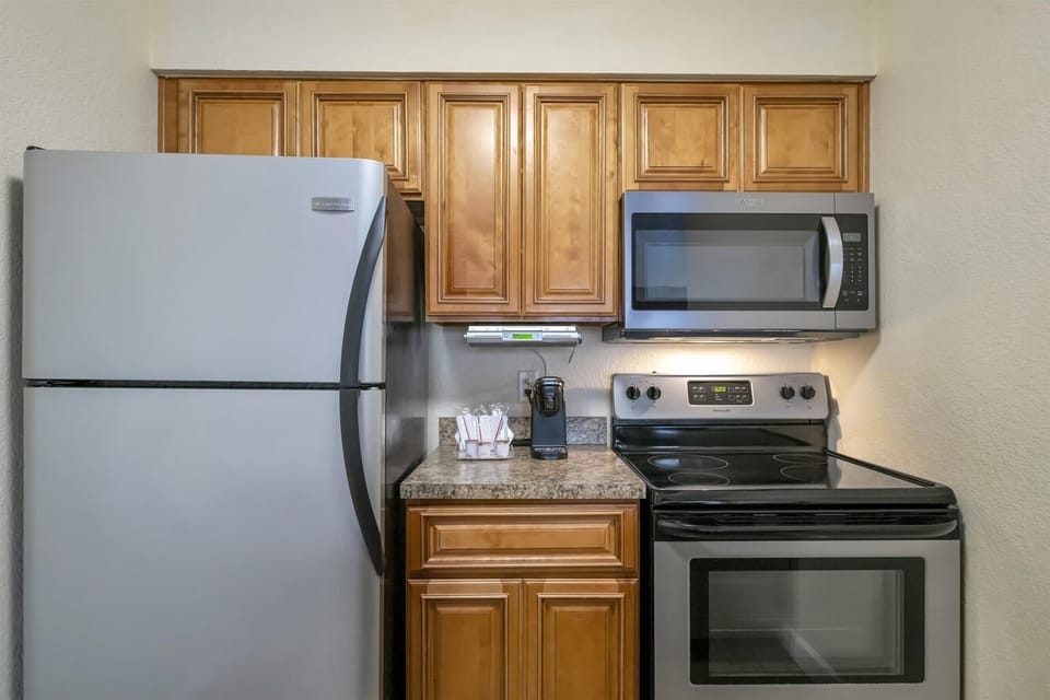Full kitchen with fridge, microwave, and stove
