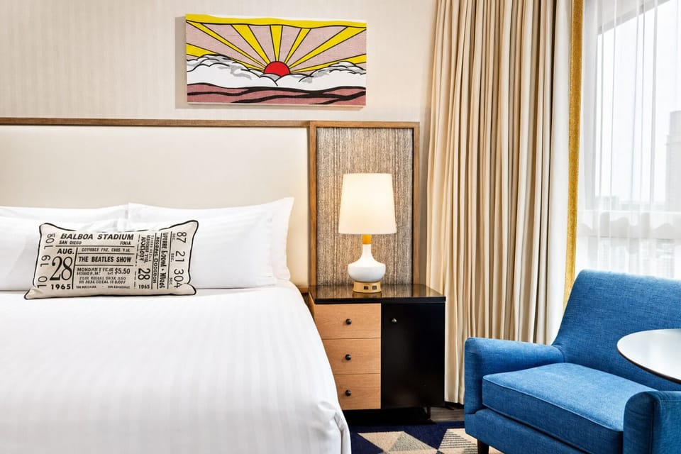 Sink into plush pillows beside warm, inviting bedside glow.