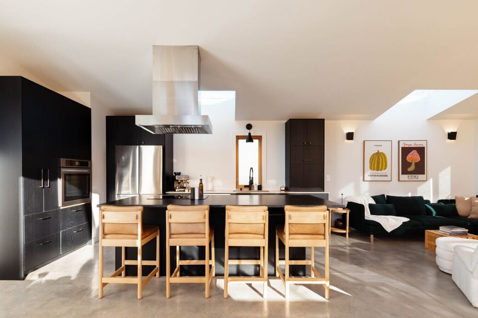 Expansive, open‑concept kitchen on the upper level, with clean lines, rich textures, and generous counter space designed for effortless gathering.