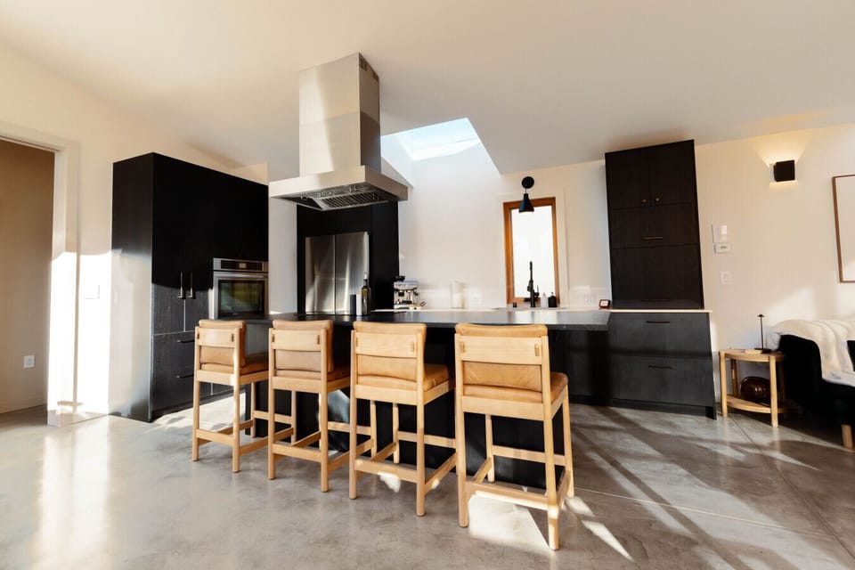Sleek chef’s kitchen with a generous island and bar seating - your own modern wine‑and‑dine hub.