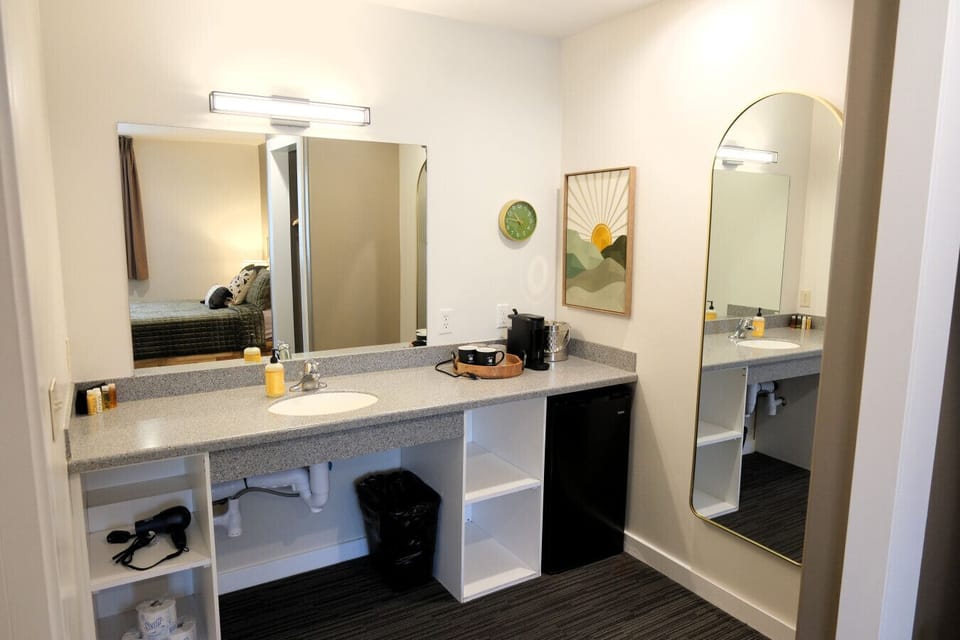 Large vanity with mirror, mini fridge, and coffee setup—perfect for getting ready before exploring downtown Moab.