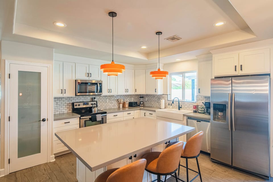 Full chef’s kitchen with stainless steel appliances, spacious counters, and island seating — perfect for cooking at home or hosting group dinners.
