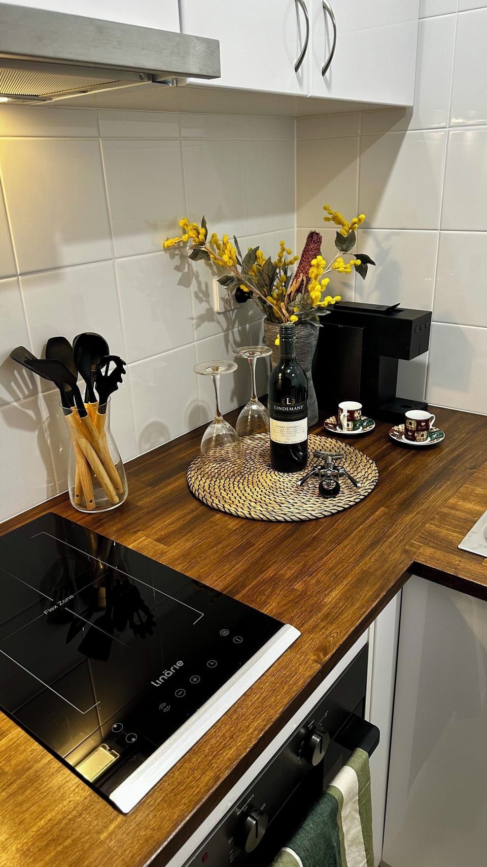 kitchen with electric cooktop, rangehood, oven, microwave and kitchen essentials