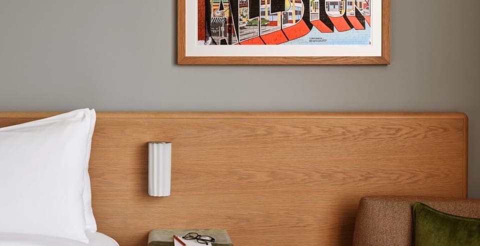 Admire curated art and warm wood accents before bed.