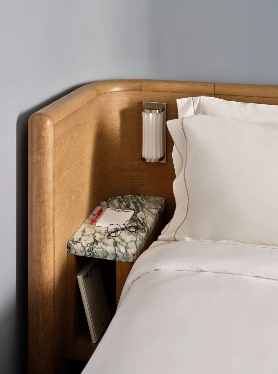 Settle in with bedside lighting and a marble perch.