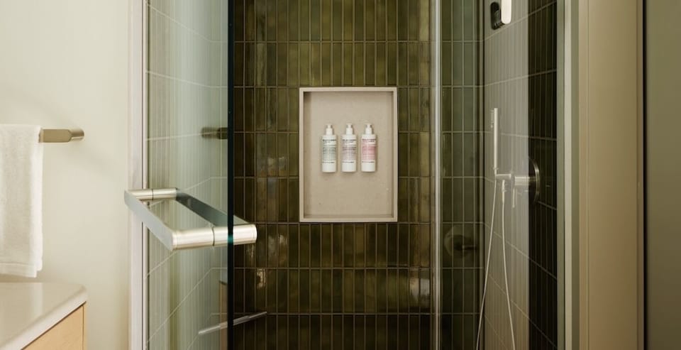 Rinse off in a modern glass shower with premium toiletries.