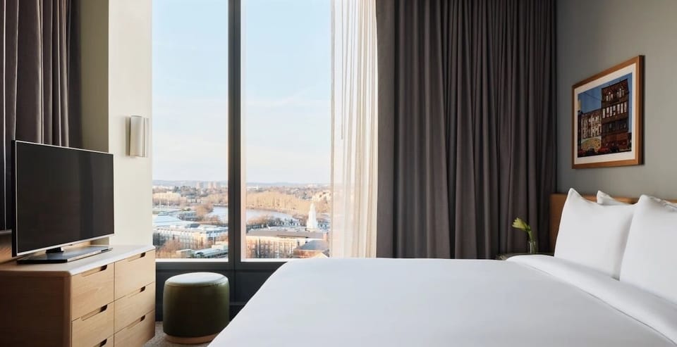 Wake up to skyline views in crisp, cloud-soft bedding.