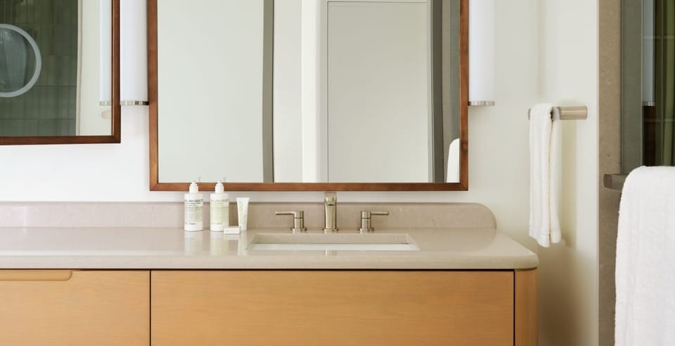 Refresh at the sleek vanity with spa-like lighting and mirrors.