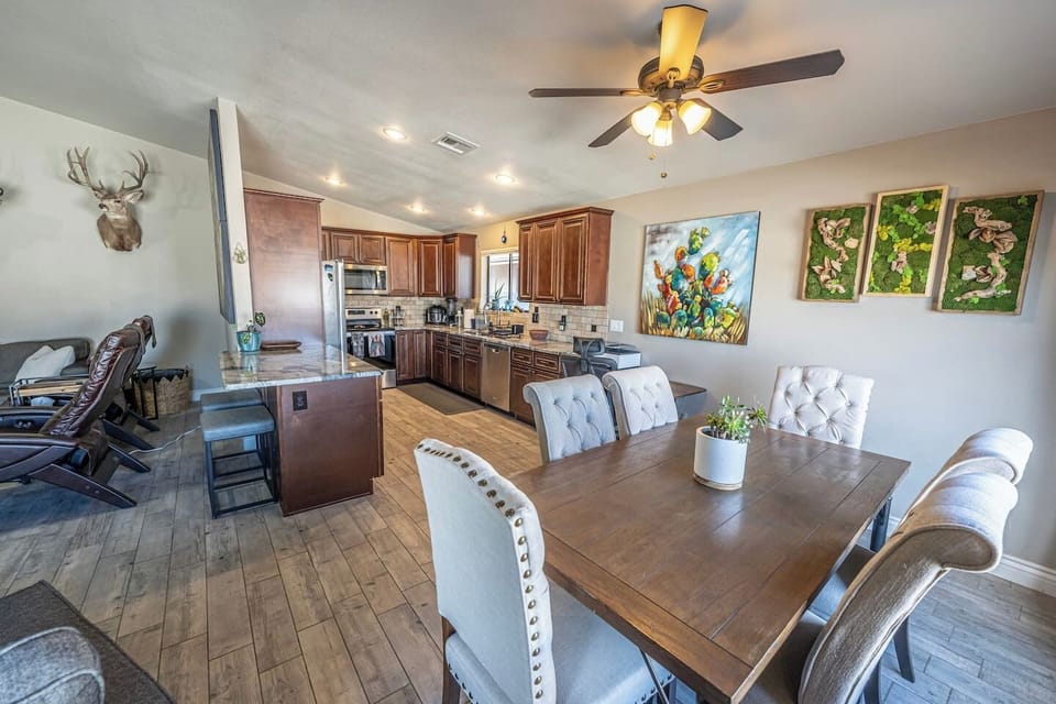 Dining area with seating for 6 at the table, plus additional seating for 2 at the kitchen island.