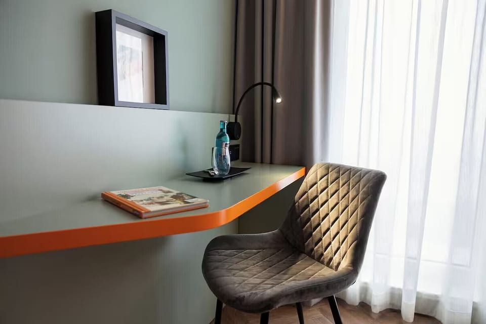 Unwind with a quiet desk setup by soft curtains.
