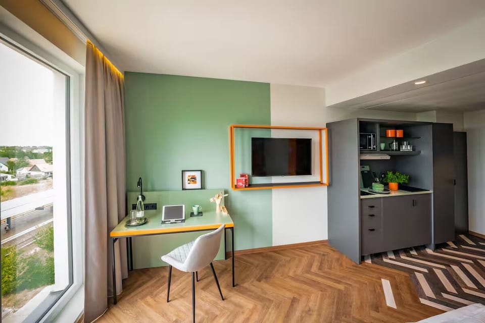 Settle in with a bright workspace and sleek kitchenette.