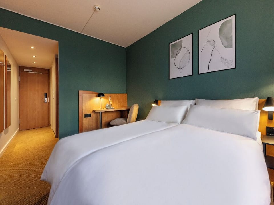 Settle into a serene room with warm lighting and plush bedding.