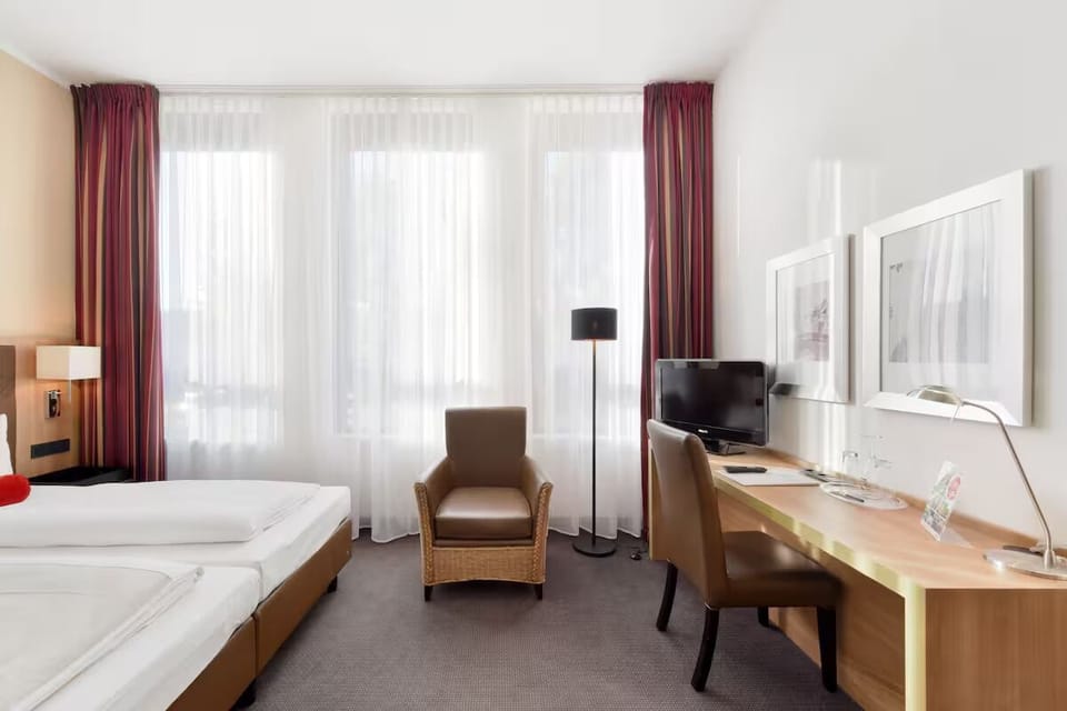 Relax after meetings in a bright twin room with seating.
