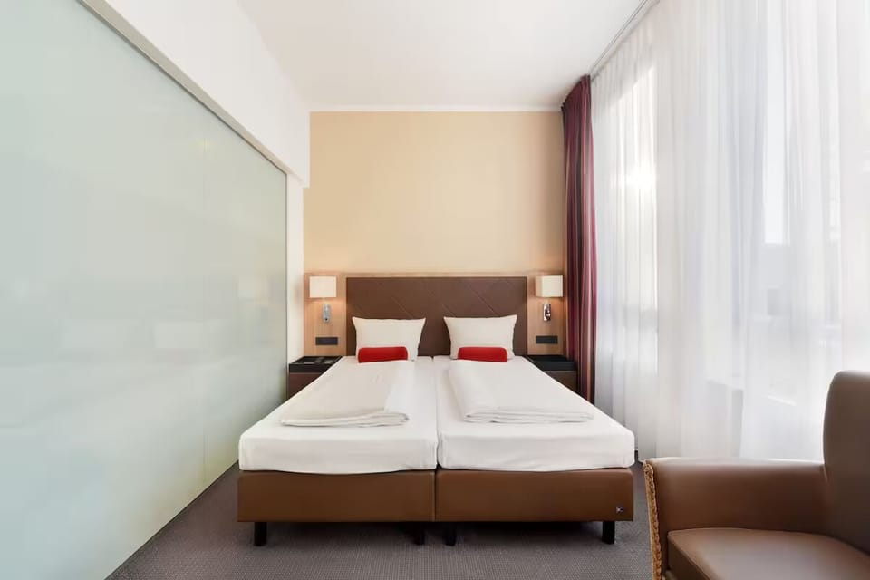 Sink into crisp twin beds with soft reading lights.