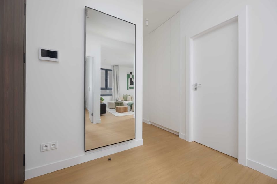 The living room offers a bright and airy space for relaxation.