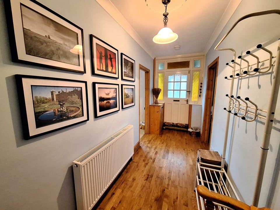 Hallway with decorative features and front porch door area.