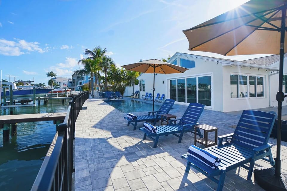 Enjoy the backyard with sun loungers and outdoor dining areas.