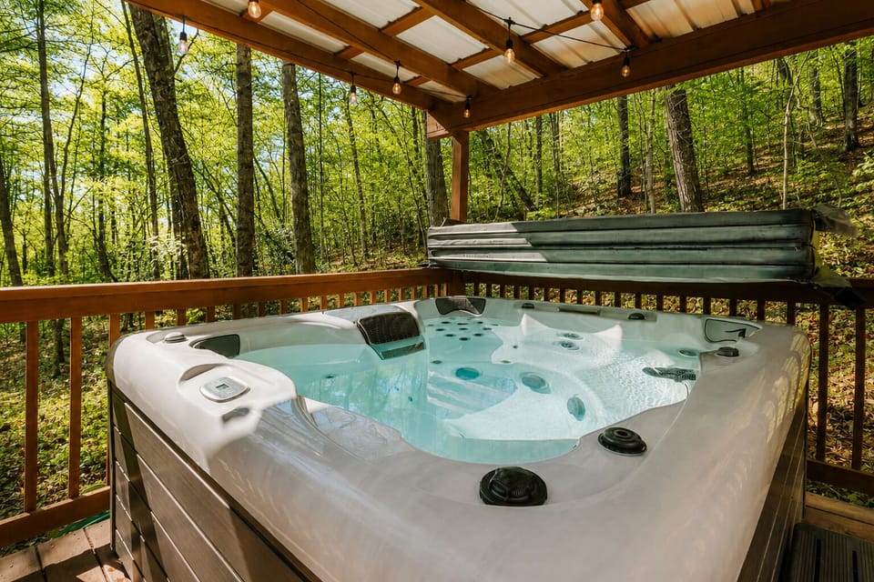 Slip into the hot tub on the covered deck and soak beneath the glow of string lights, surrounded by the quiet of the woods. Enjoy year round relaxation in any weather, whether it’s a crisp fall evening or a summer night under the stars.