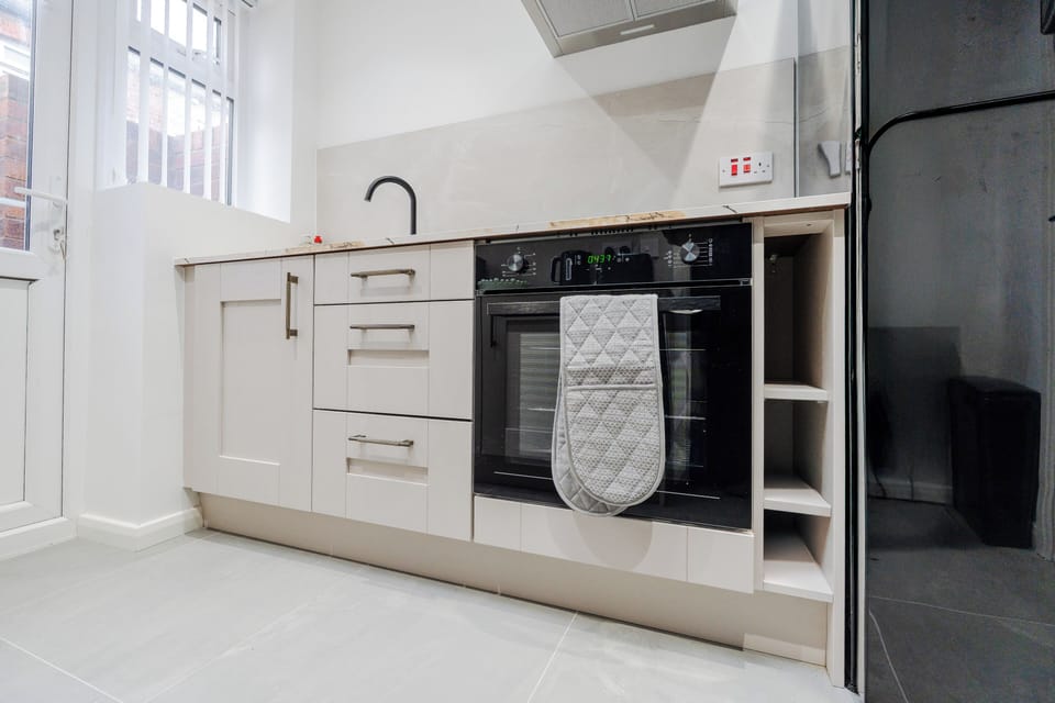 A fully fitted kitchen equipped with everything you need for a comfortable stay, including modern appliances and all the essentials for cooking, dining, and longer visits.