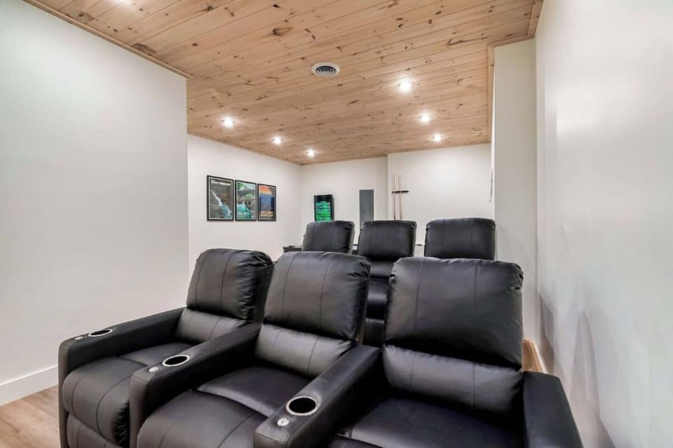 Sink into plush theater seating beneath warm wood ceilings for your private movie nights.