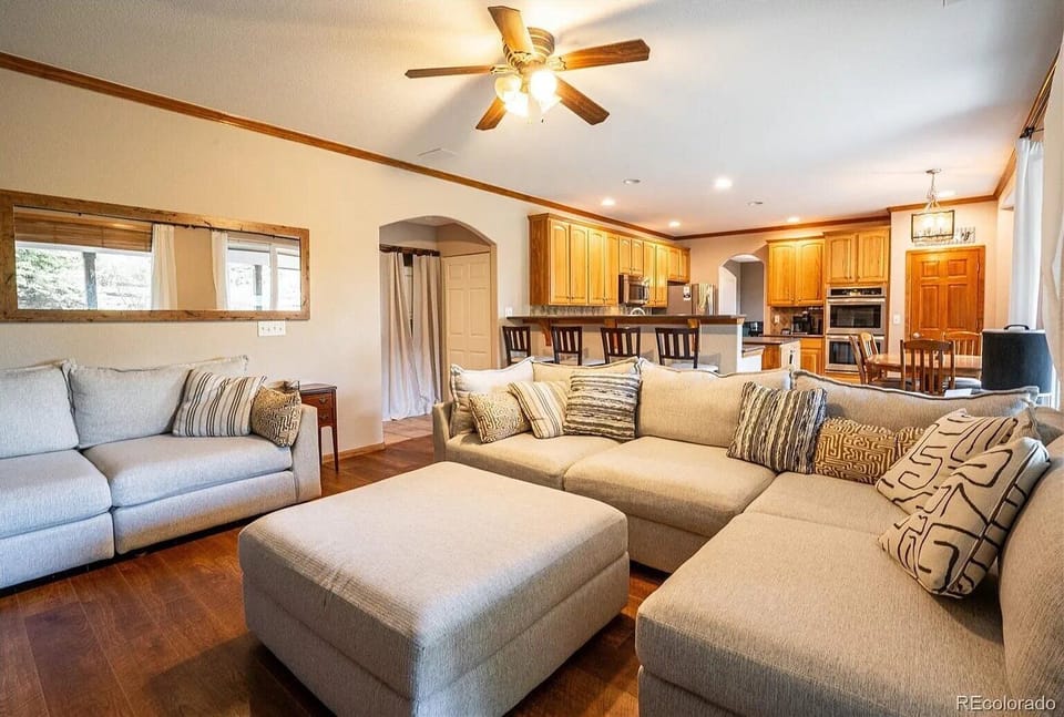 Sink into plush sectional seating in your spacious living area, where natural light streams through windows and the open kitchen awaits your culinary adventures.