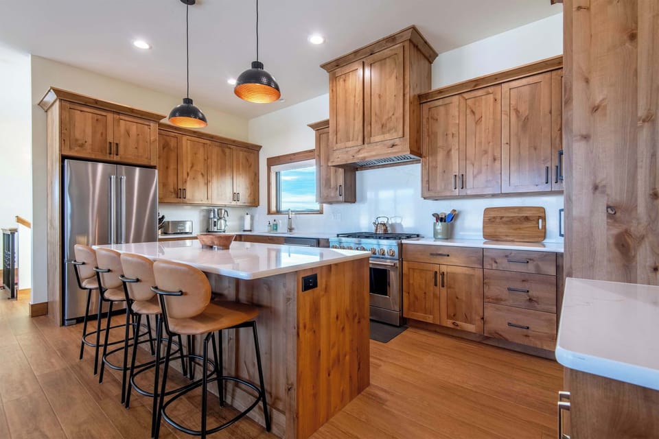 Fully equipped kitchen with island seating and modern appliances.
