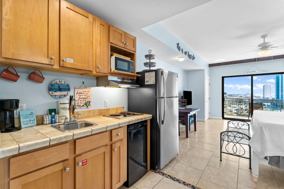Your fully equipped kitchen features warm wood cabinets, stainless appliances, and stunning city views for memorable meal preparation.