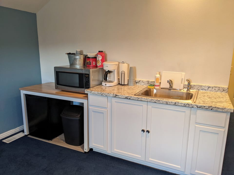 Kitchenette with microwave, coffee maker, and mini fridge. (No stove/oven)