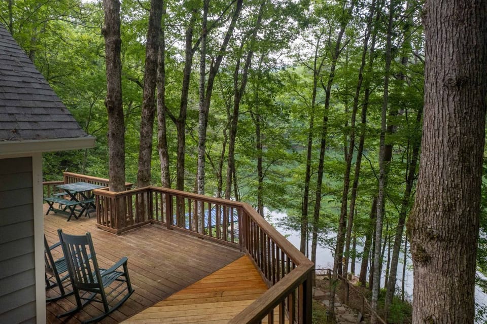 Deck with Scenic Lake View: Unwind on the spacious deck amidst towering trees and serene waters!