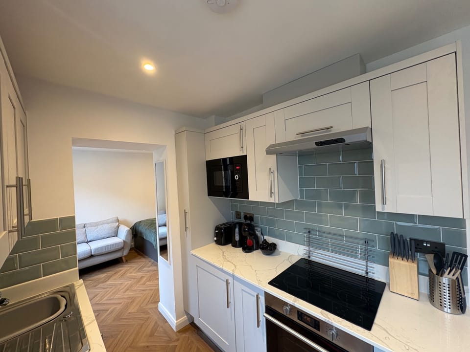 The bright kitchen is fully equipped with brand new appliances; an under counter fridge with a small freezer/ice compartment; microwave; electric oven & hob; washer/dryer; steam iron & ironing board; Nespresso coffee maker, toaster & kettle.