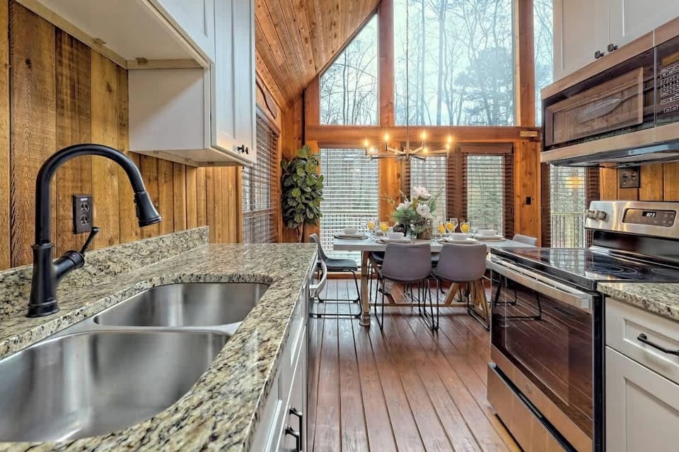 With modern touches throughout featuring stainless steel appliances, granite counters, and an abundance of natural light from the wall of windows, chefs will be in their "happy place" while cooking in our cedar cabin kitchen. 