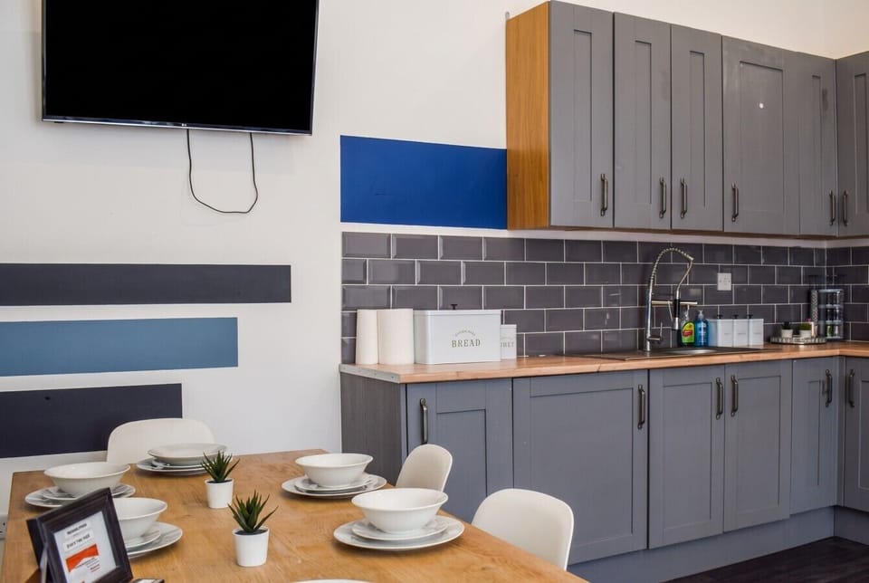 Dine at the table beside the kitchen units and splashback.