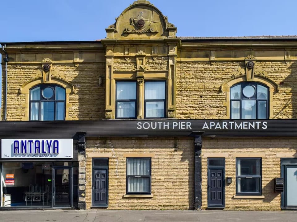 The street-facing frontage shows the “South Pier Apartments” building exterior.