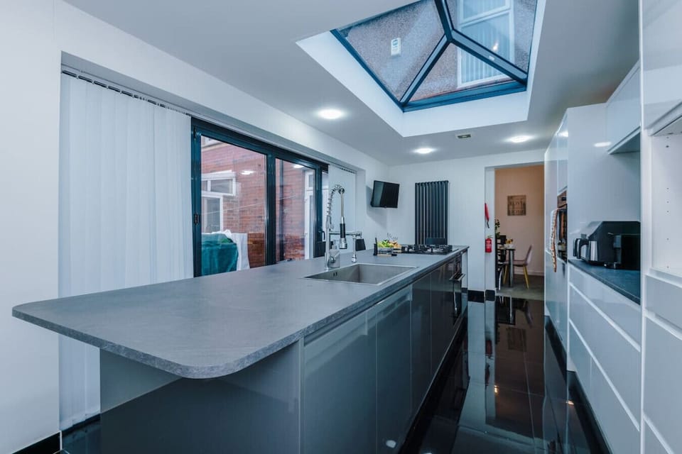 This long kitchen run shows the worktops, appliances, and skylight for day-to-day cooking.