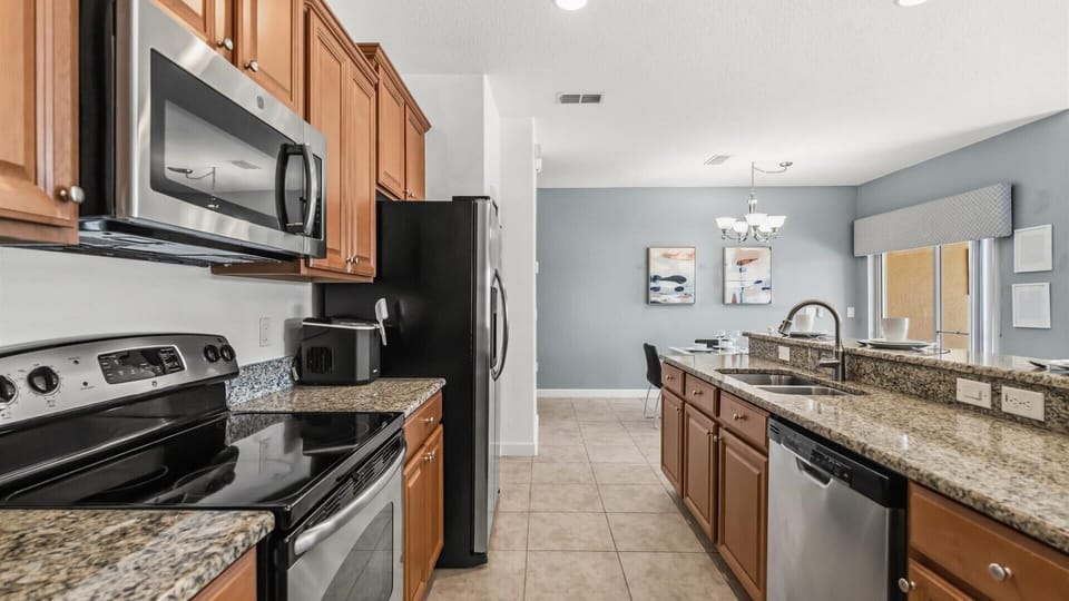 Fully Equipped Kitchen: Cook your favourite meals in this modern kitchen featuring stainless steel appliances and granite countertops.
