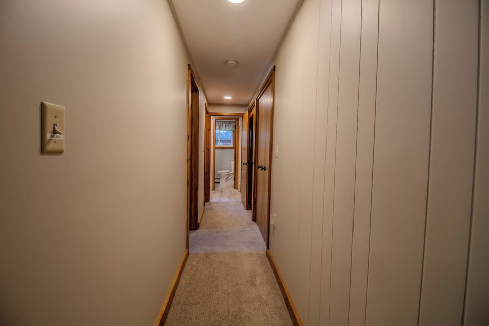 Hallway - Same hallway from the opposite vantage. You can see the half bathroom near the mud room at the end of the hallway.